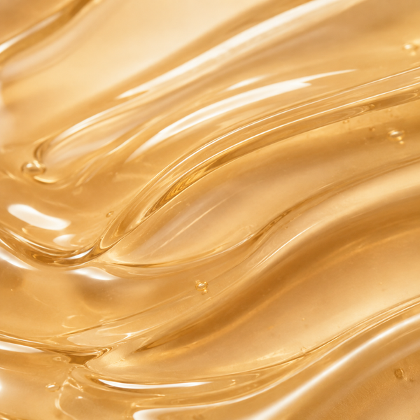 Detalle macro de la textura oleosa dorada del aceite Body Sculptor
